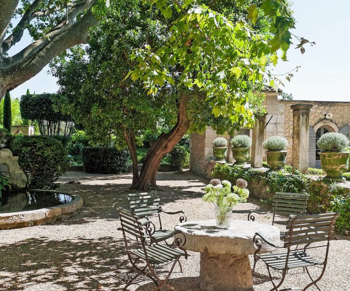 Gravel courtyard and topiary at a Champagne château
