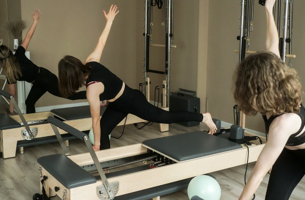 Reformer pilates session in a bright community studio